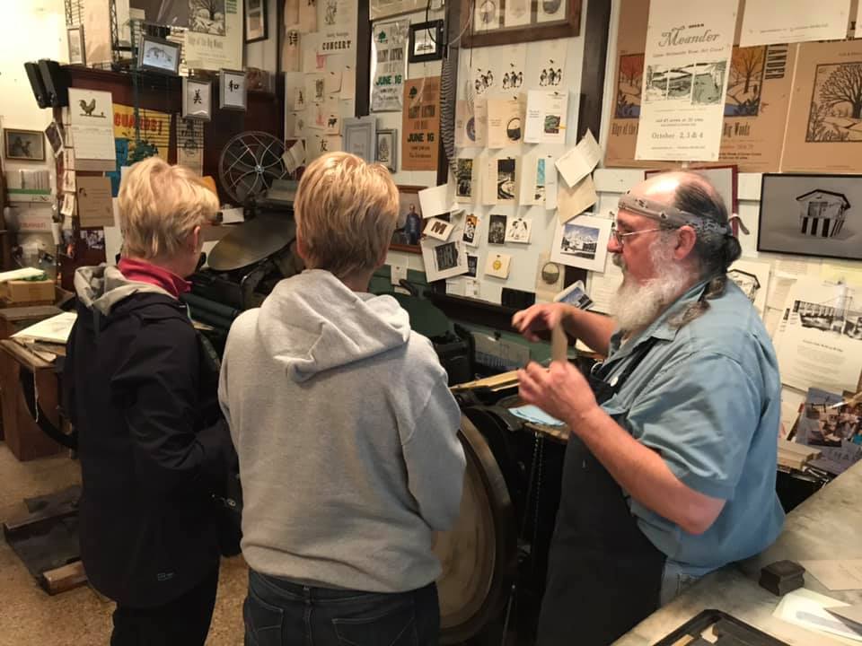 Andy demonstrates how he prints cards on his letterpress.