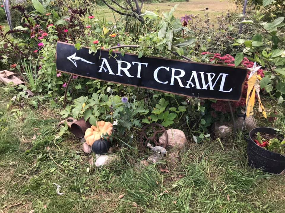 Art Crawl sign placed in a fall garden.